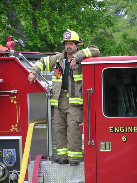 Lt. Tom Algiere mans the pump on E6 at a hydraulics practical in June of '04 behind the DCFD Grange property.